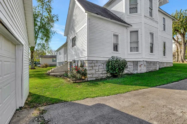 a view of a house with a yard and sitting area