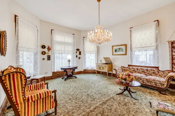 a living room with furniture a chandelier and a chandelier