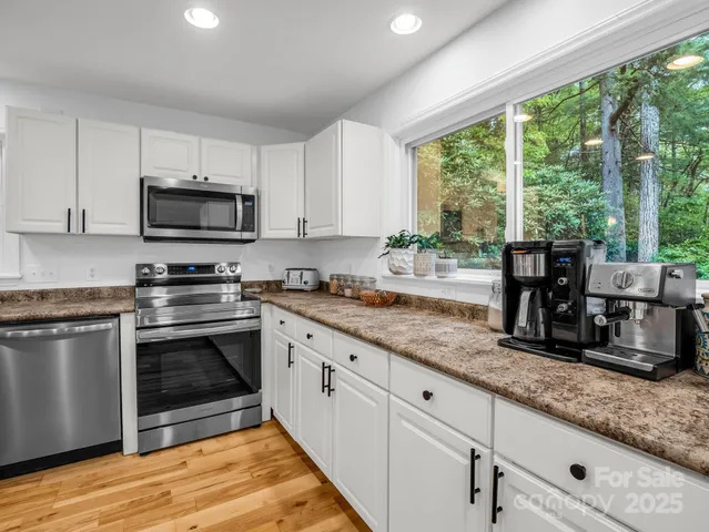 a kitchen with granite countertop a stove and a sink