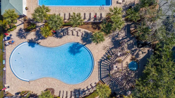 an aerial view of a swimming pool patio and outdoor seating
