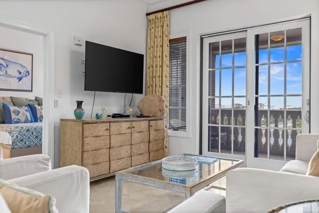 a bedroom with a bed a dresser and potted plants on the dresser