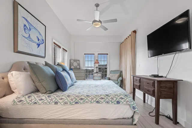 a bedroom with a bed and a lamp on dresser