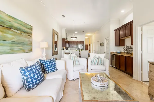 a bedroom with a bed a dresser and potted plants on the dresser