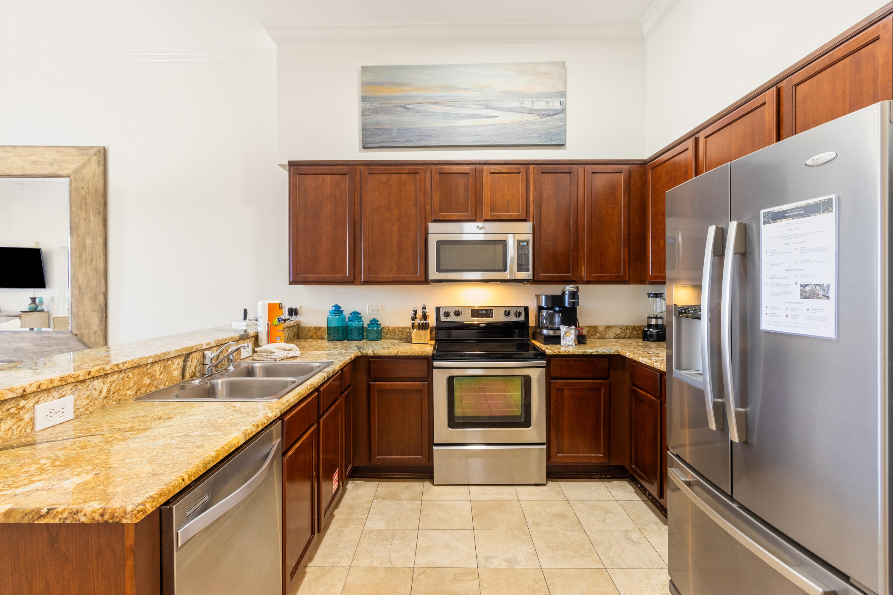 10343 East County Highway 30A, Unit 305 Inlet Beach, FL 32413 - Photo 42 of 60 a kitchen with stainless steel appliances granite countertop a sink stove microwave and refrigerator