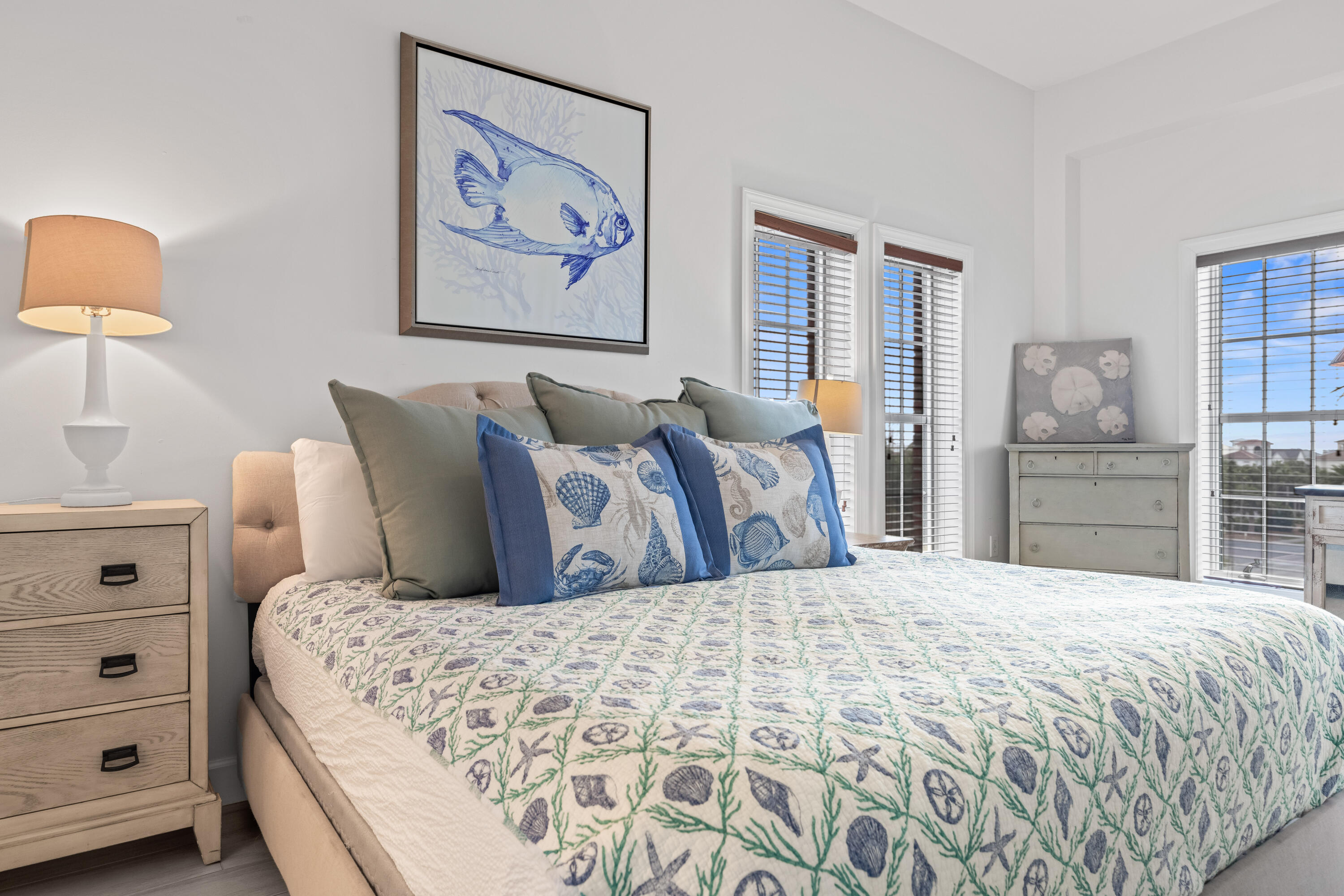 10343 East County Highway 30A, Unit 305 Inlet Beach, FL 32413 - Photo 45 of 60 a bedroom with a bed and a lamp on dresser