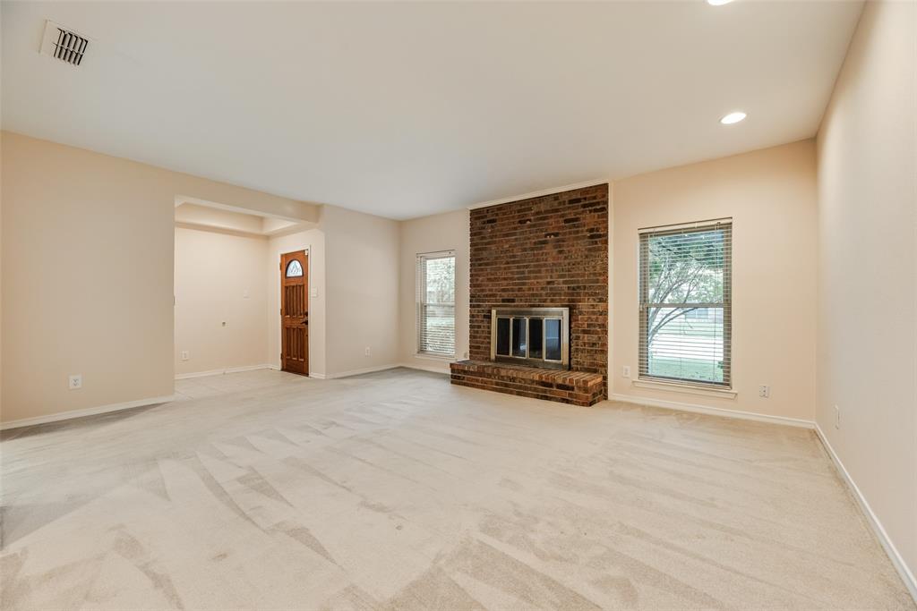 4988 Thunder Road Dallas, TX 75244 - Photo 4 of 32 Spacious room featuring a brick fireplace, neutral carpet, and recessed lighting