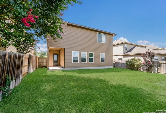 a view of a house with backyard and garden