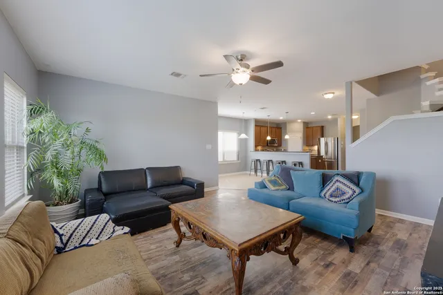a view of a workspace with furniture and a window