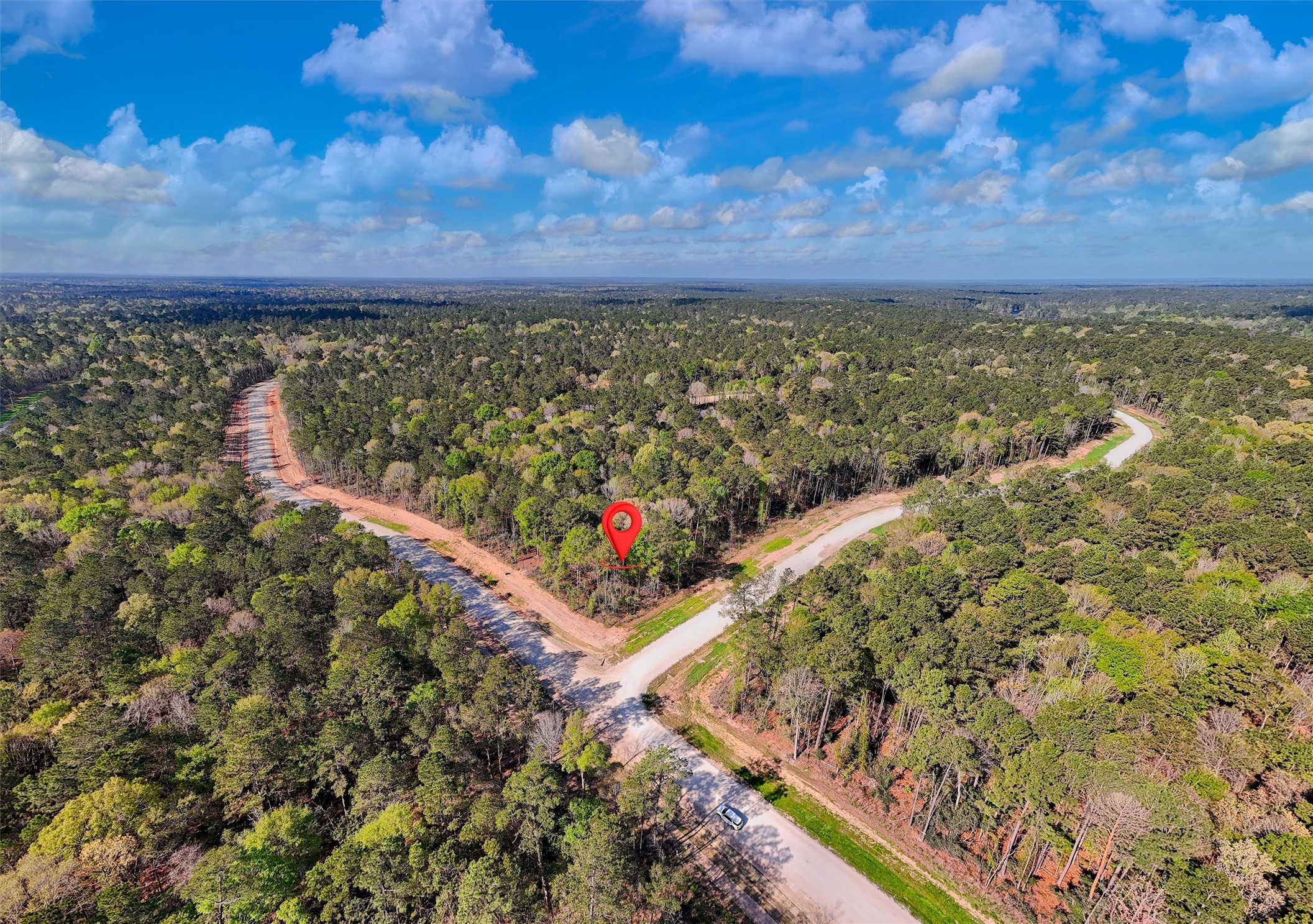 111 Rustic Ranch Drive New Waverly, TX 77358 - Photo 2 of 9 Prime 1.38-acre corner lot located within the desirable Estates of Grand Texas, offering multiple access points, surrounded by mature trees.