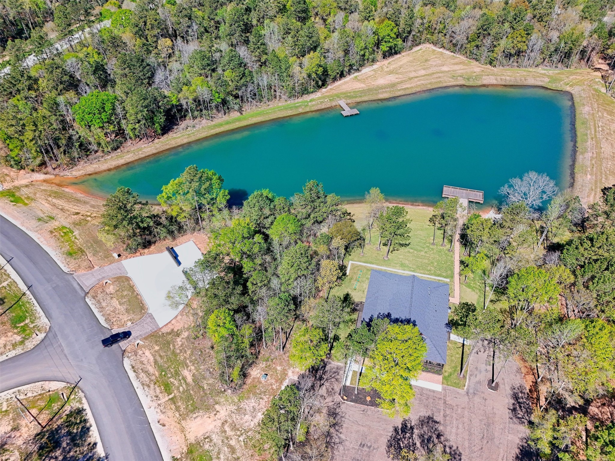 111 Rustic Ranch Drive New Waverly, TX 77358 - Photo 8 of 9 Community pond offering a picturesque setting for relaxation and outdoor enjoyment, enhancing the lifestyle this neighborhood provides.