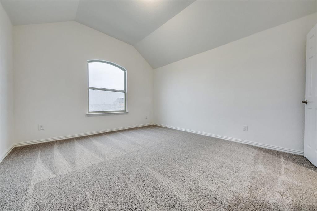 104 Sweetleaf Drive Red Oak, TX 75154 - Photo 20 of 36 This room features plush grey carpet, neutral white walls, and a distinctive arched window that allows for natural light