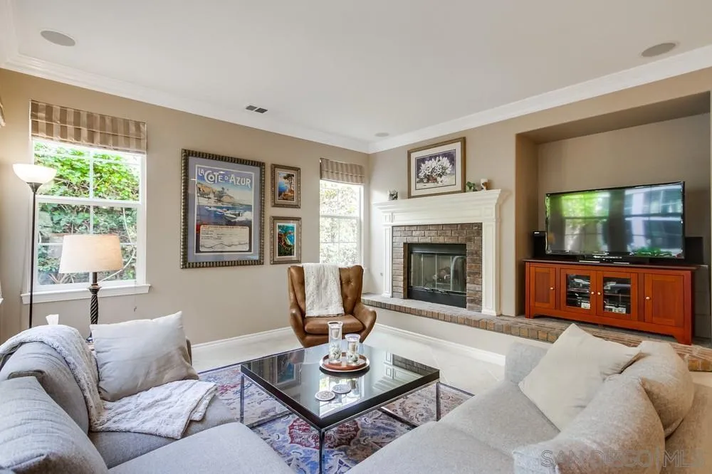 2665 Paradise Road Carlsbad, CA 92009 - Photo 13 of 52 a living room with furniture a window and a fireplace