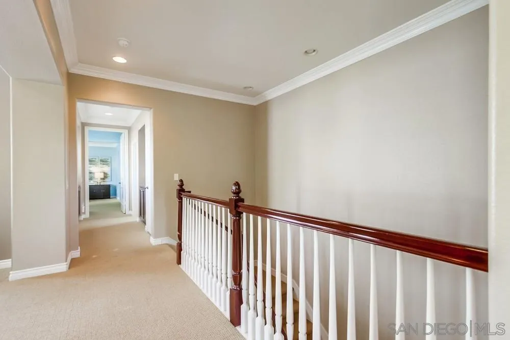 2665 Paradise Road Carlsbad, CA 92009 - Photo 18 of 52 a view of a hallway with wooden floor and stairs