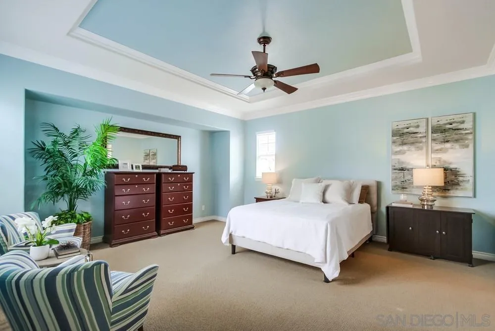 2665 Paradise Road Carlsbad, CA 92009 - Photo 19 of 52 a bedroom with a bed and dresser with mirror