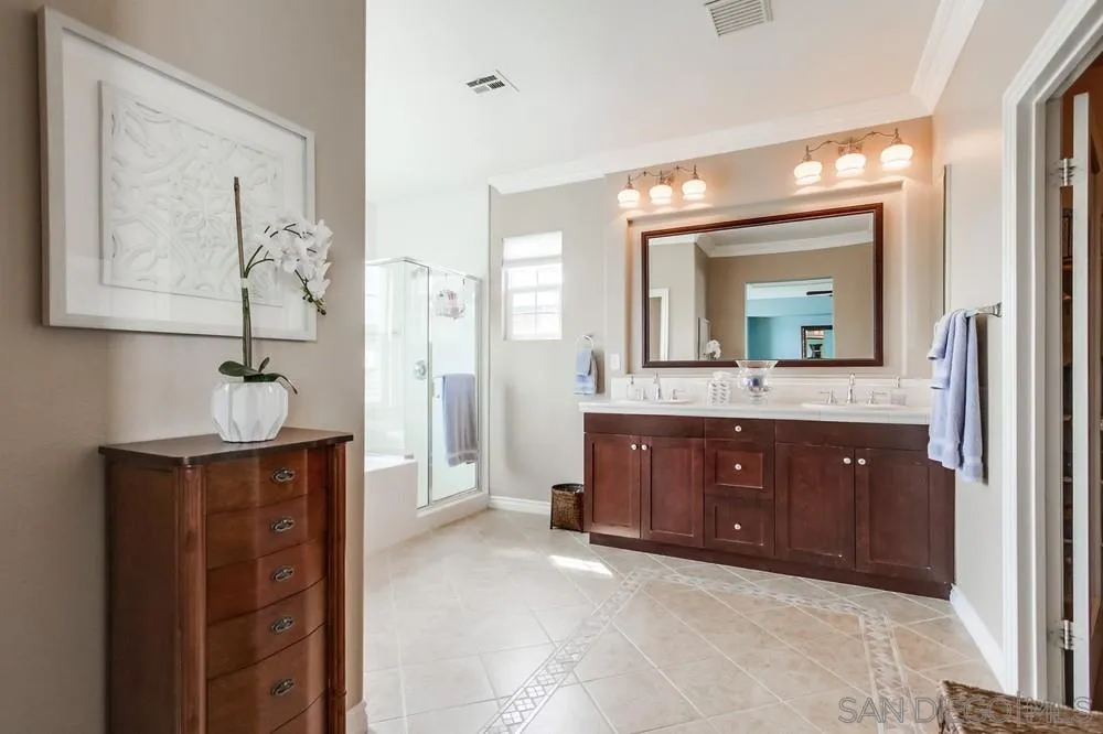 2665 Paradise Road Carlsbad, CA 92009 - Photo 22 of 52 a spacious bathroom with a double vanity sink and a mirror
