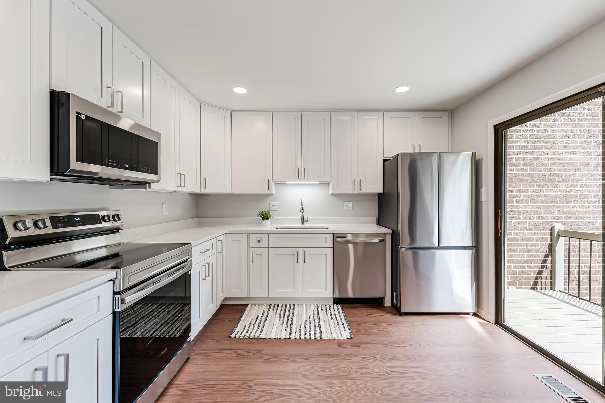 12023 Insha Court Reston, VA 20191 - Photo 20 of 52 a kitchen with a refrigerator stove and microwave