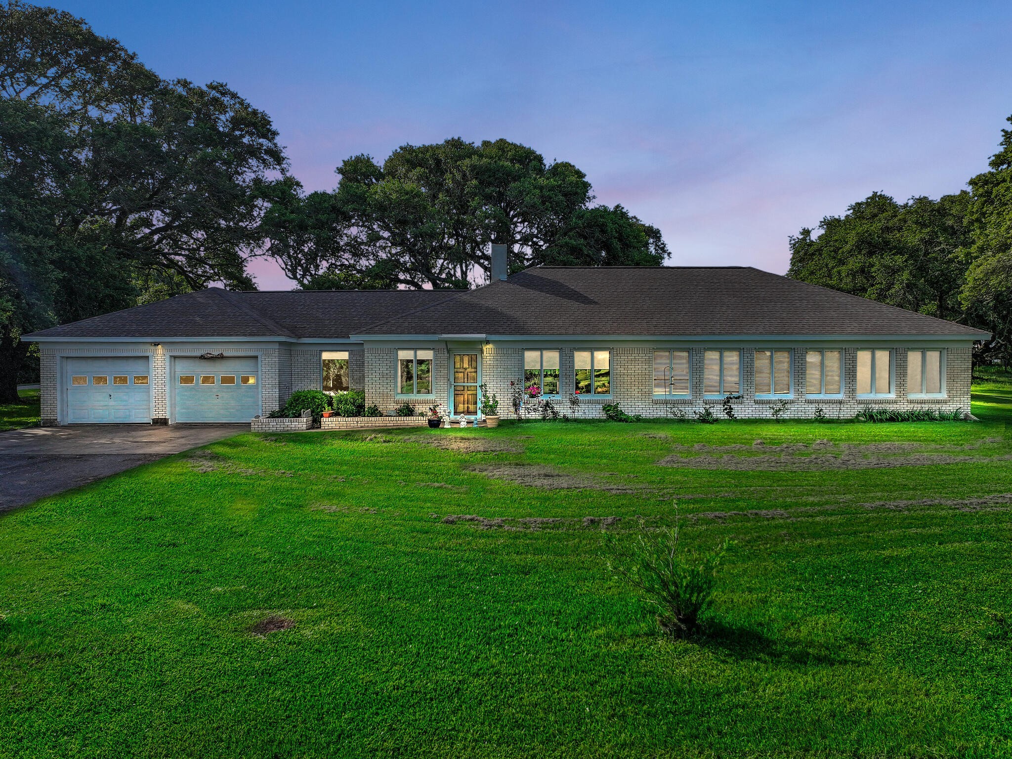 1212 High School Road Port Bolivar, TX 77650 - Photo 2 of 50 a front view of a house with a yard table and chairs
