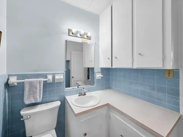 a bedroom with furniture and a potted plant