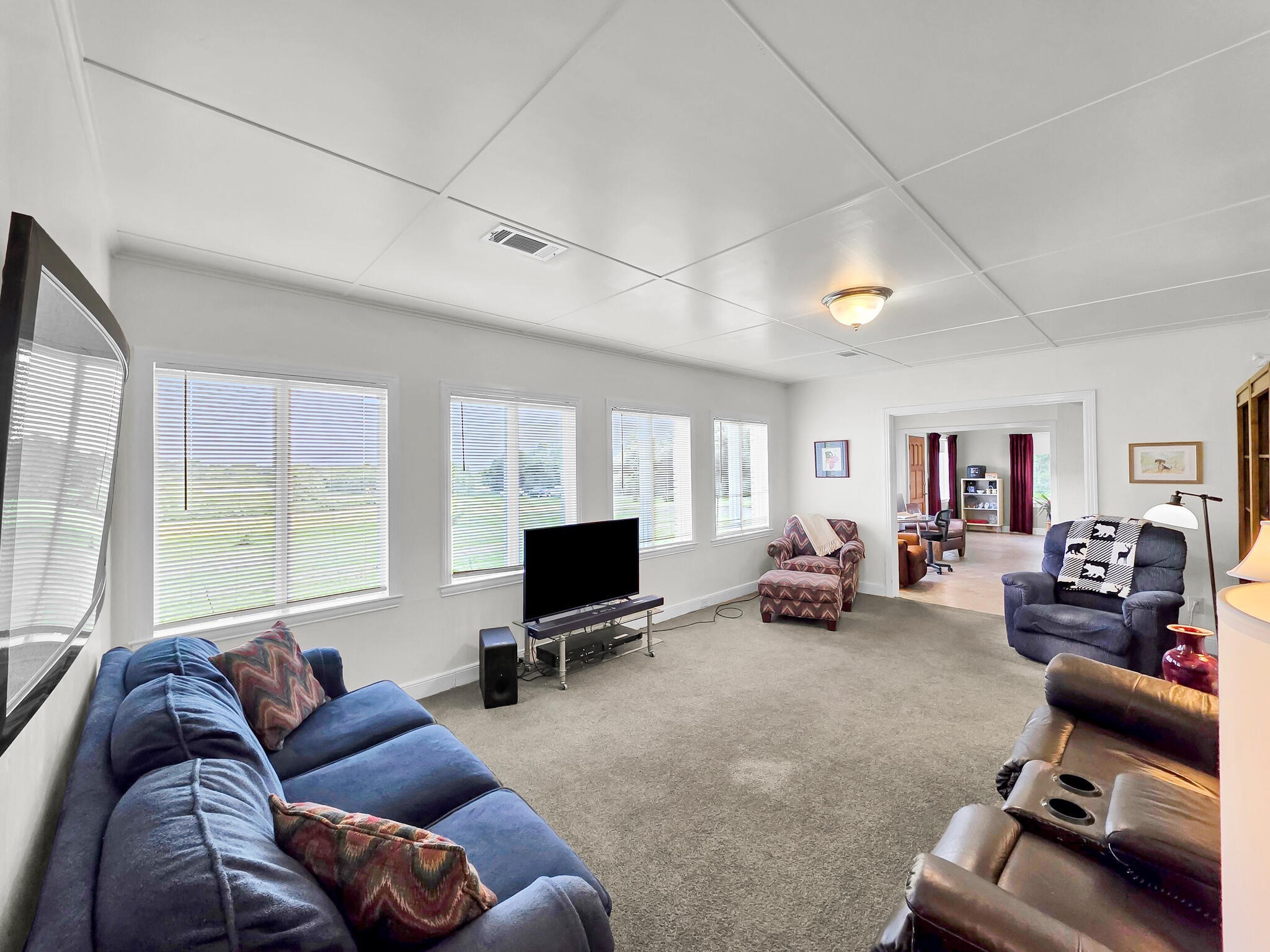 1212 High School Road Port Bolivar, TX 77650 - Photo 43 of 50 a living room with furniture a flat screen tv and a large window