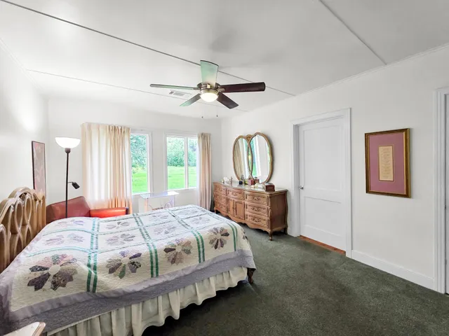 a bedroom with a bed and a dresser