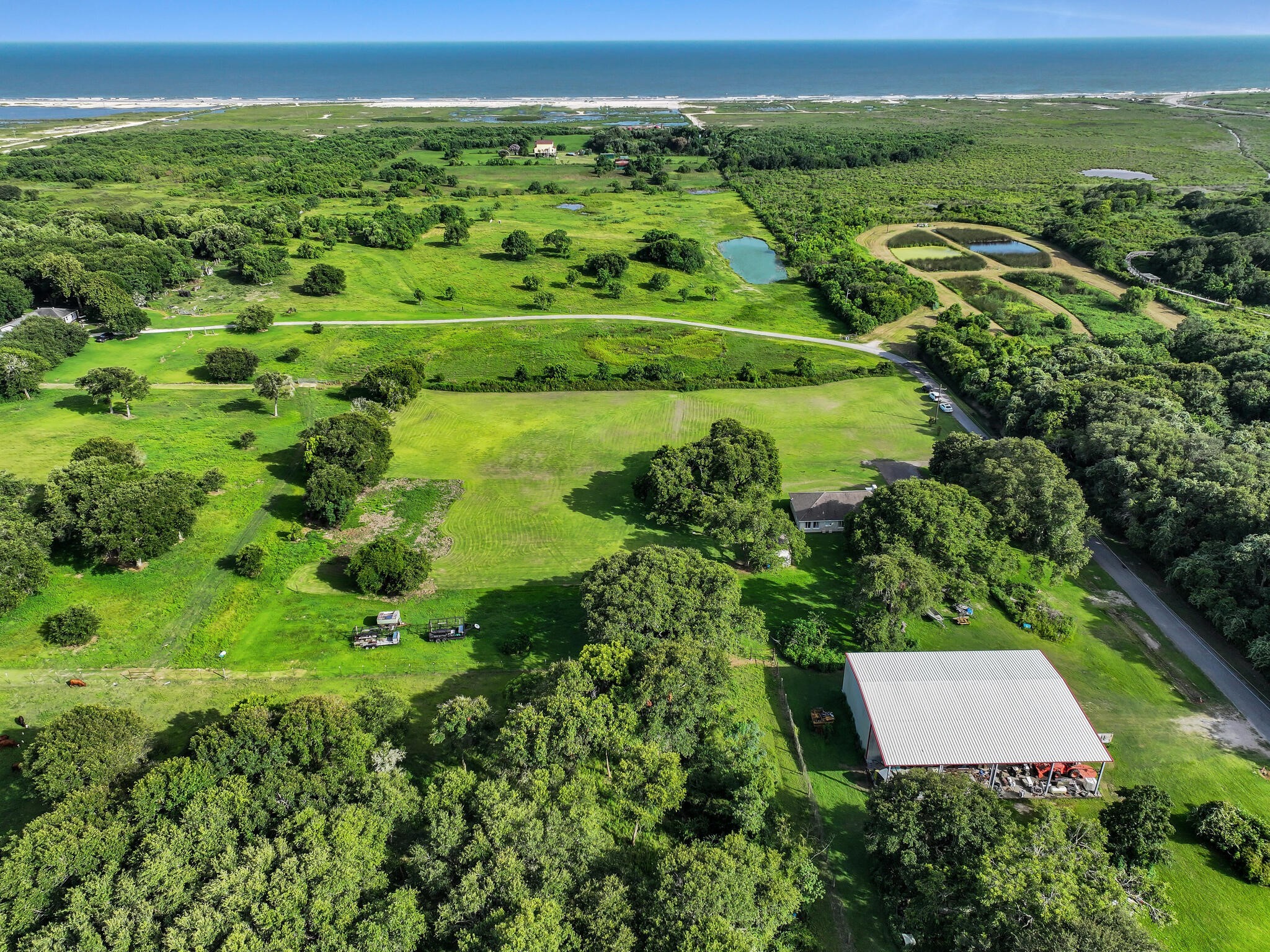 1212 High School Road Port Bolivar, TX 77650 - Photo 6 of 50 a view of a green field with lots of green space