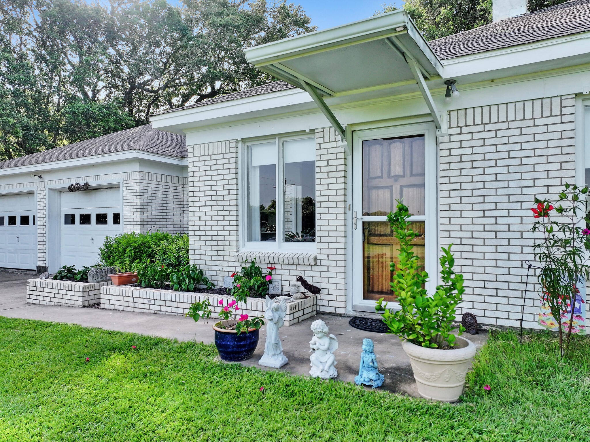 1212 High School Road Port Bolivar, TX 77650 - Photo 10 of 50 a front view of a house with a garden and plants