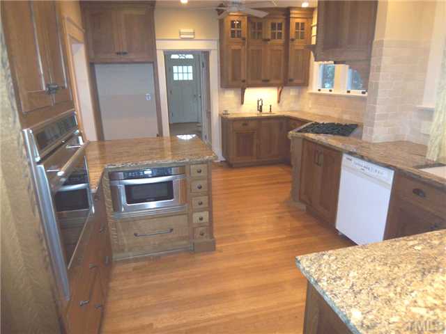 912 West Johnson Street Raleigh, NC 27605 - Photo 2 of 12 a kitchen with stainless steel appliances granite countertop a stove a sink and a refrigerator