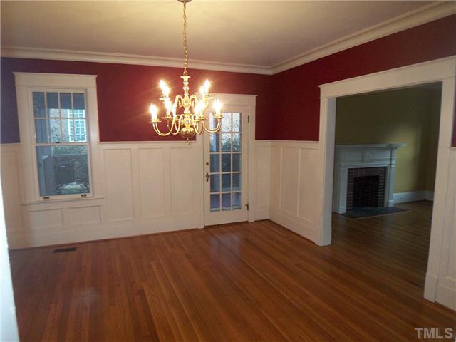 912 West Johnson Street Raleigh, NC 27605 - Photo 5 of 12 a view of a livingroom with a fireplace wooden floor and chandelier