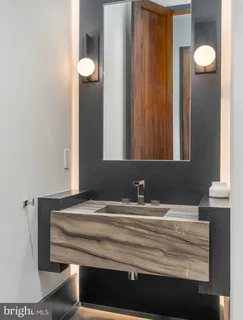 a bathroom with a double vanity sink mirror and shower