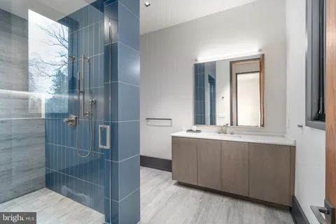a bathroom with a double vanity sink mirror and toilet