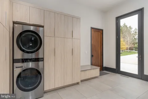 a view of a hallway with wooden floor and closet