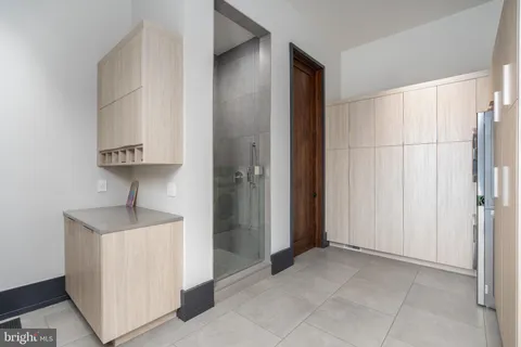 a living room with a large window and white walls