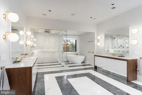 a bathroom with a bathtub shower sink mirror and toilet