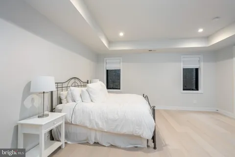 a swimming pool view with a seating space and a garden view