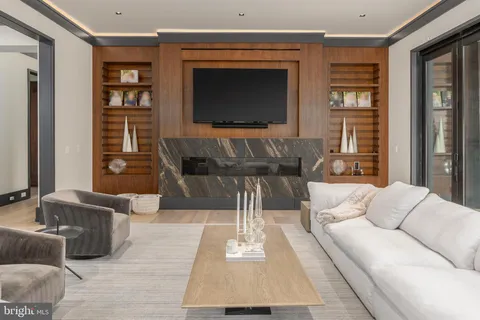 a living room with fireplace furniture and a flat screen tv
