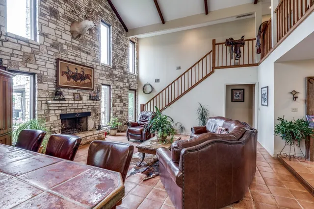 a bedroom with a large bed and wooden floor