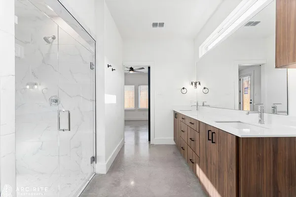 a bathroom with a double vanity sink a toilet and a mirror