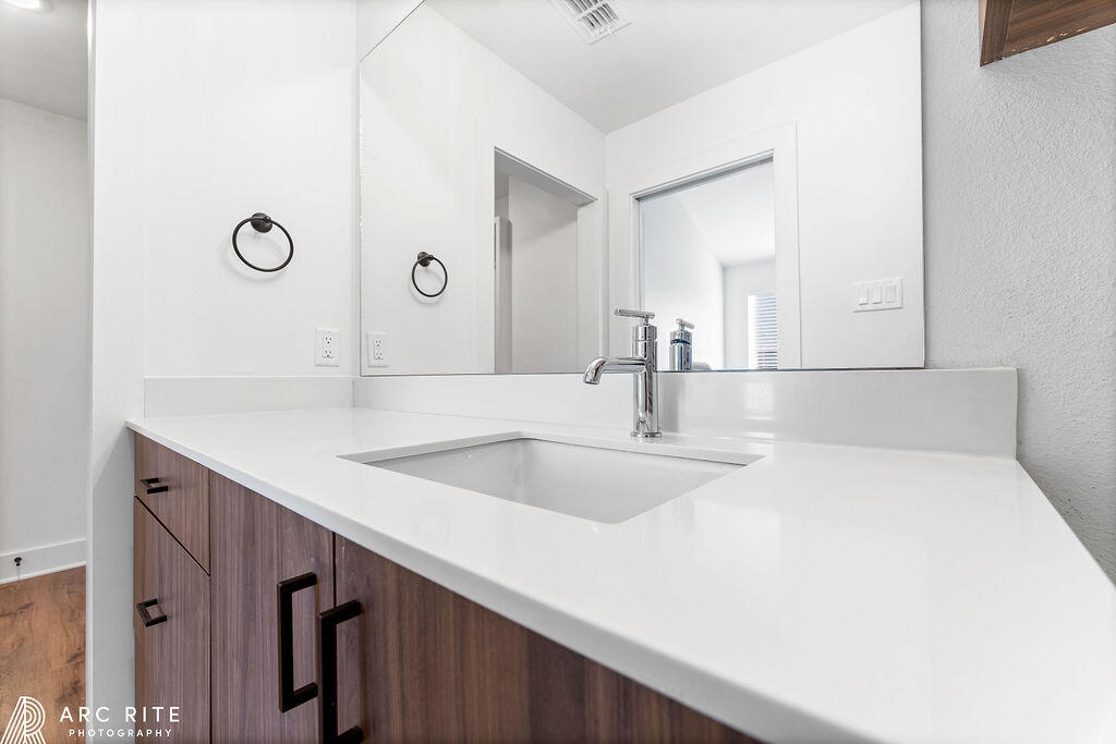 4509 22nd Place Lubbock, TX 79407 - Photo 18 of 32 a bathroom with a sink and a mirror