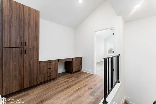 a view of a hallway with wooden floor