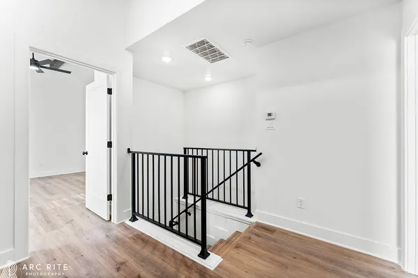 a view of an empty room and wooden floor