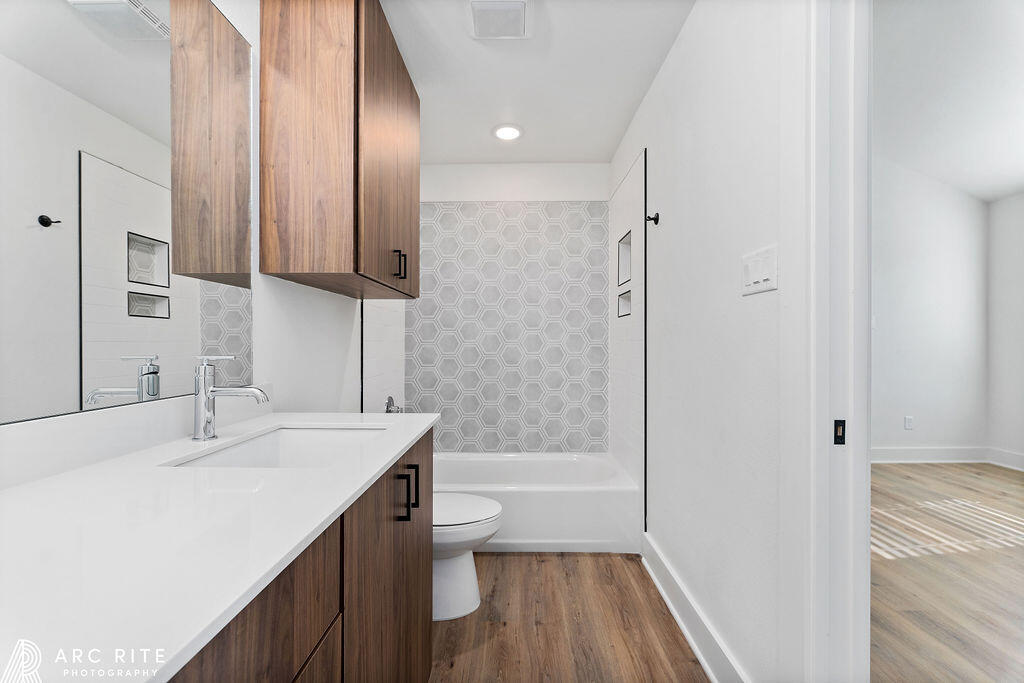 4509 22nd Place Lubbock, TX 79407 - Photo 22 of 32 a bathroom with a sink a toilet a tub and shower
