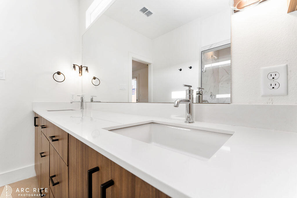 4509 22nd Place Lubbock, TX 79407 - Photo 26 of 32 a bathroom with a sink and a mirror