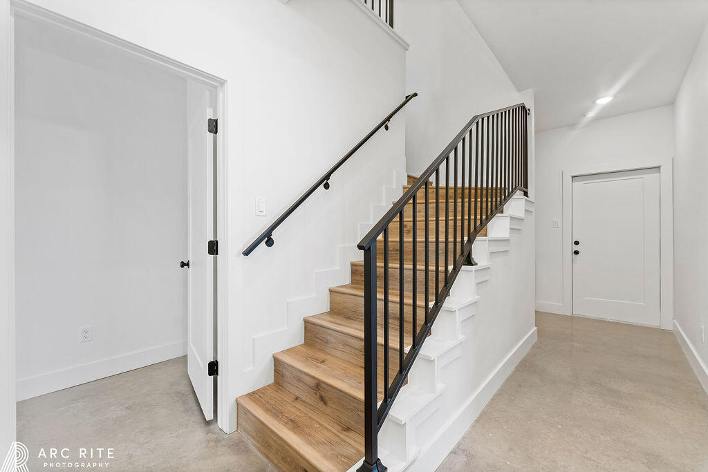 4509 22nd Place Lubbock, TX 79407 - Photo 29 of 32 a view of staircase with wooden floor and white walls