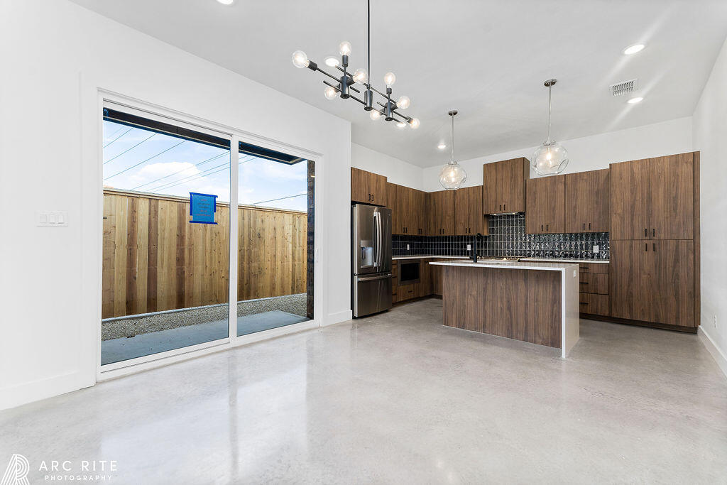 4509 22nd Place Lubbock, TX 79407 - Photo 3 of 32 a large kitchen with kitchen island a large counter top stainless steel appliances and cabinets