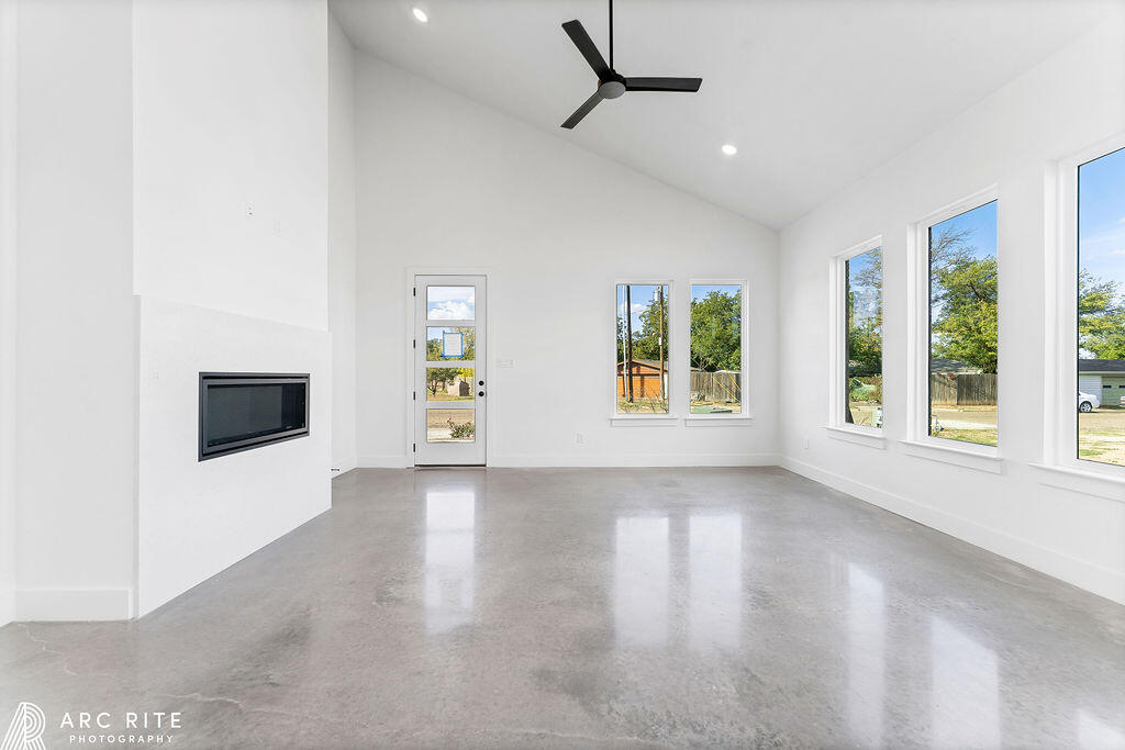 4509 22nd Place Lubbock, TX 79407 - Photo 6 of 32 a view of an empty room with a window and wooden floor