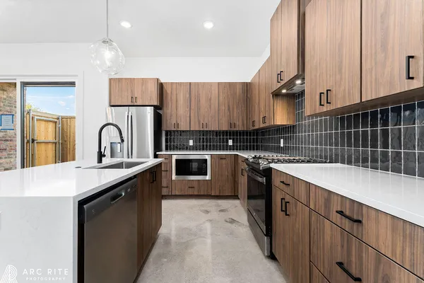 a kitchen with stainless steel appliances a refrigerator sink and cabinets
