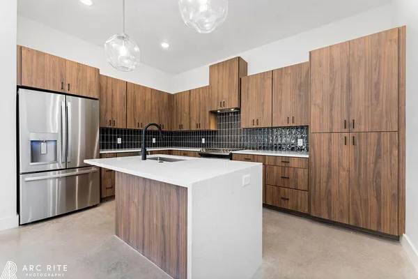 a kitchen with granite countertop a stove and a sink