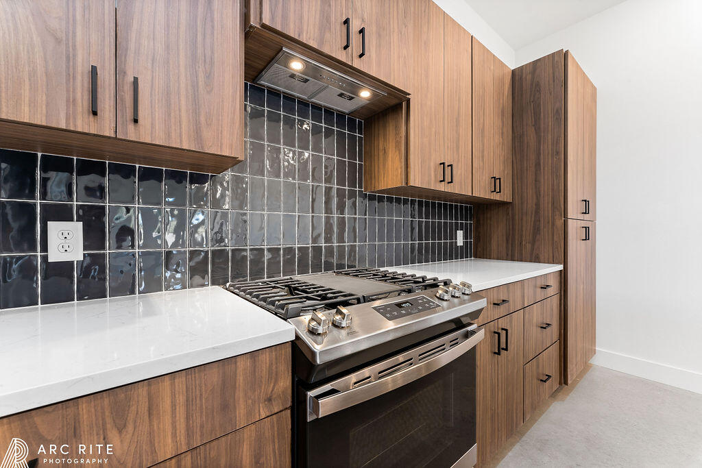 4509 22nd Place Lubbock, TX 79407 - Photo 10 of 32 a kitchen with granite countertop a stove and a sink