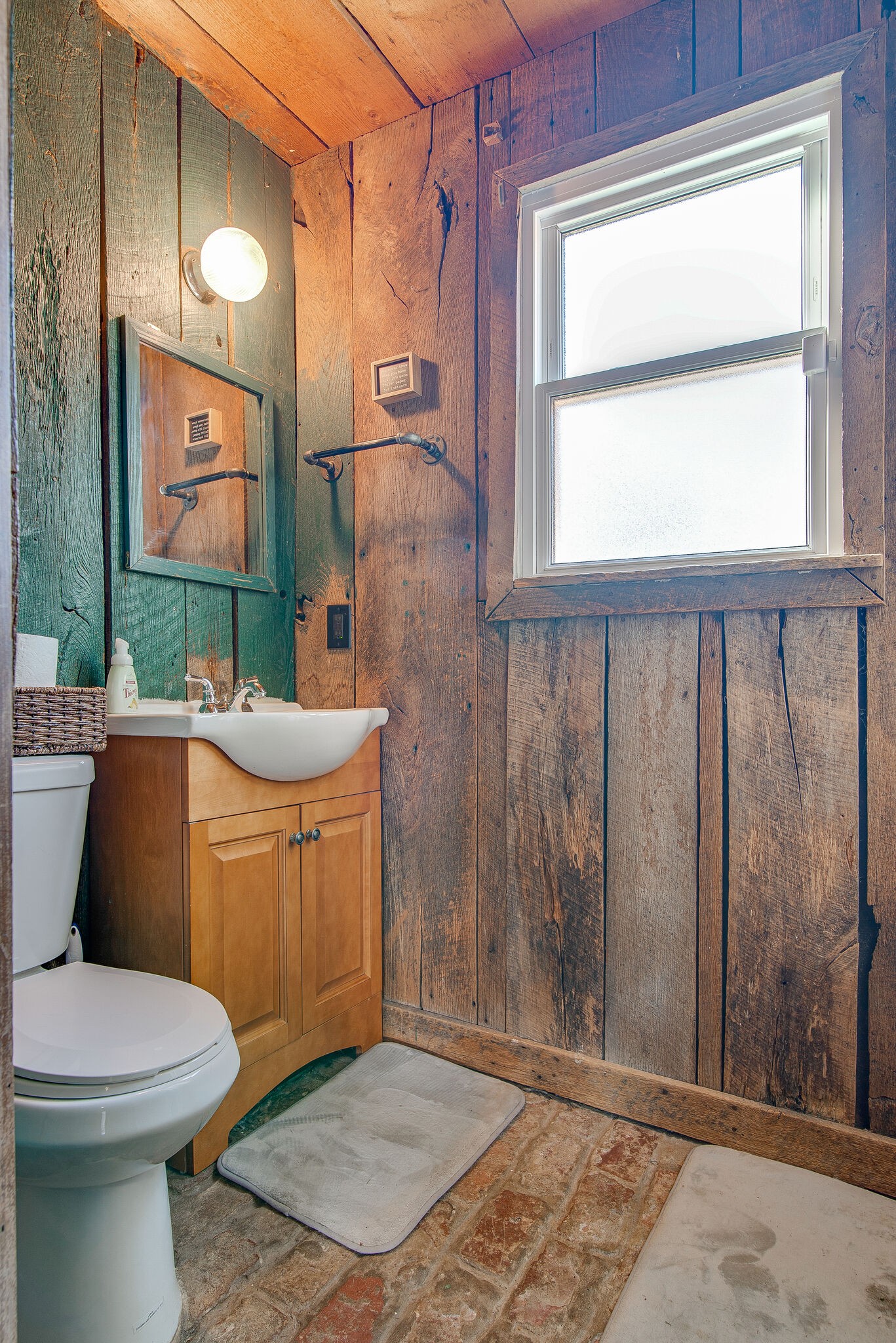 1225 Neelys Bend Road Madison, TN 37115 - Photo 29 of 32 a bathroom with a toilet a sink and a mirror