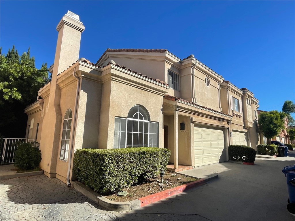 10010 Reseda Boulevard, Unit D Northridge, CA 91324 - Photo 1 of 22 a front view of a house with a garden